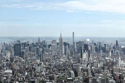 High angle shot of cityscape against calm sea