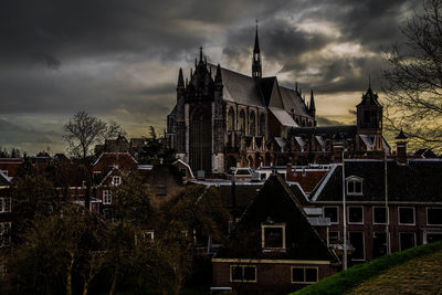 Buildings in city against sky at dusk