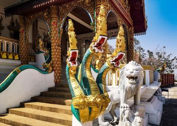 Statue outside temple by building