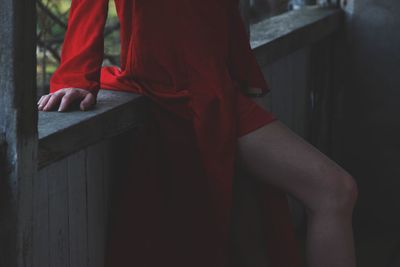 Midsection of woman standing by railing