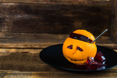 Close-up of orange slice in plate on table