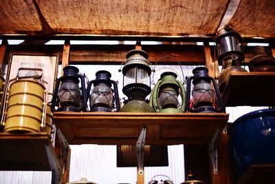 Low angle view of bottles hanging in shelf