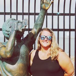 Portrait of smiling woman with sculpture