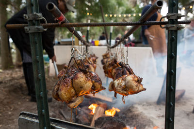 Chicken hanging over bonfire