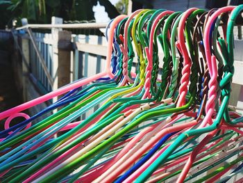 Close-up of multi colored coathangers hanging on rack
