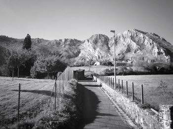 Empty road leading towards mountain