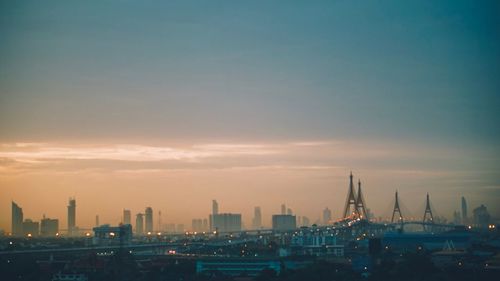 View of buildings in city against sky during sunset