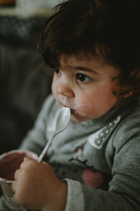 Portrait of cute child holding spoon