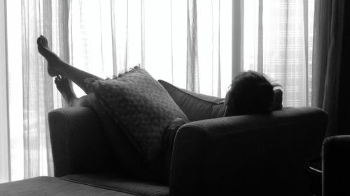 Silhouette woman relaxing on sofa at home