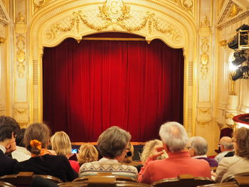 Rear view of people sitting at theater