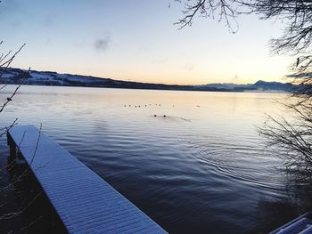 Scenic view of lake against sky during sunset