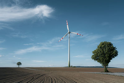 Windmill on field against sky