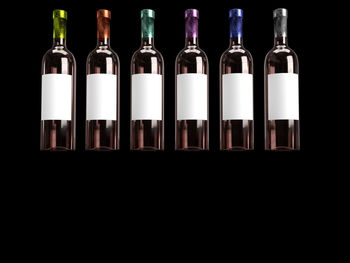 Close-up of beer bottles against black background