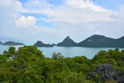 Scenic view of sea and mountains against sky