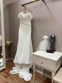 Wedding dress hanging in shop for sale