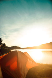 Tent by the lake at sunrise