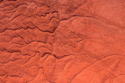 Aerial view of drought red mud surface, industry waste, abstract texture.