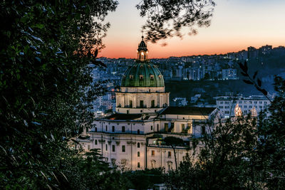 Buildings against sky during sunset