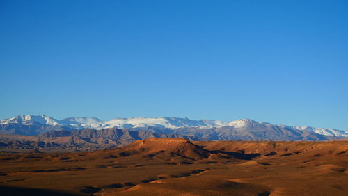 Scenic view of mountains against clear blue sky