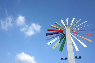 Low angle view of ferris wheel against blue sky