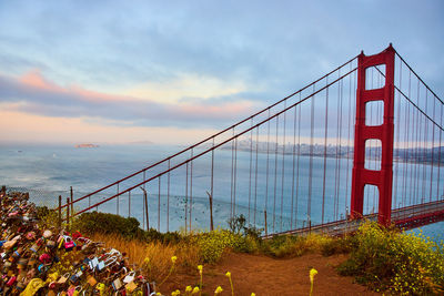 View of suspension bridge against cloudy sky