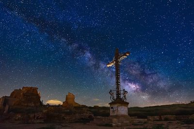 Statue against sky at night