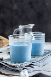 Blue drink in glasses on table