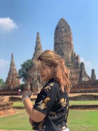 Woman standing in front of historical building