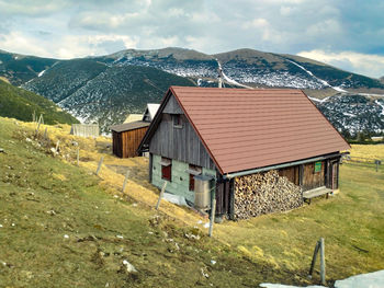 Houses by road amidst buildings against sky