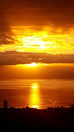 Scenic view of sea against romantic sky at sunset