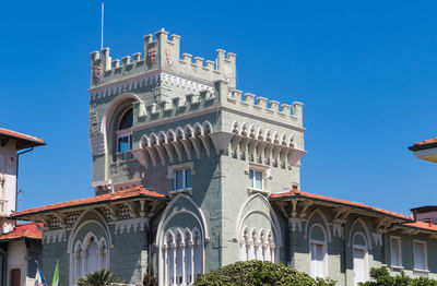 Low angle view of historical building against blue sky