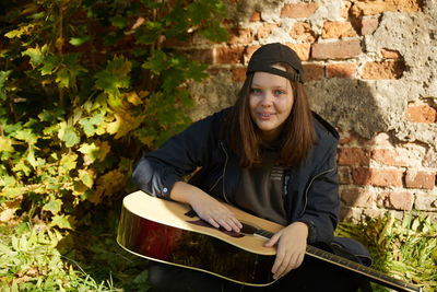 Beautiful girl with guitar outdoor