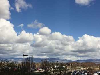 Panoramic view of people in city against sky