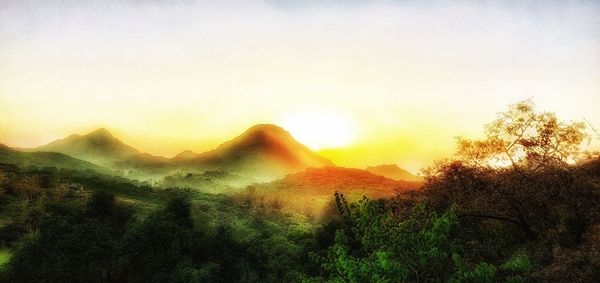 Scenic view of mountains against sky during sunset