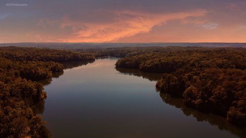 Scenic view of lake against sky at sunset