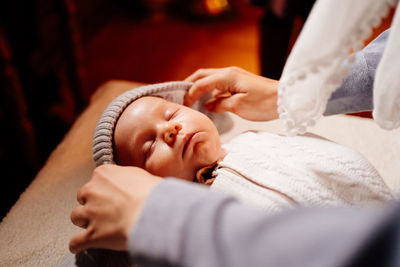 Midsection of cute baby sleeping on bed