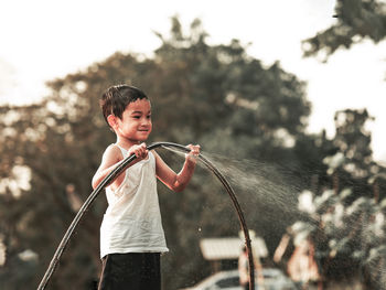 Portrait of boy standing against blurred background