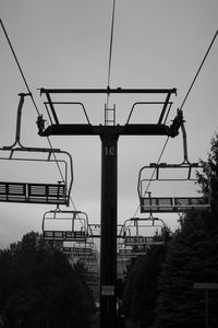 Low angle view of overhead cable car against clear sky