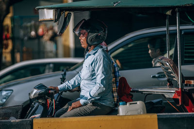 Side view of man riding motorcycle