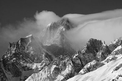 Scenic view of snow covered mountains against sky