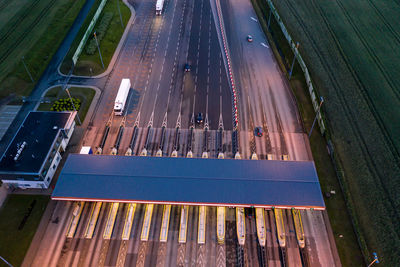 Highway road and toll collection gate, drone aerial top view at night. commuter .a2 poland lodz