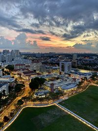 High angle view of city by river against sky