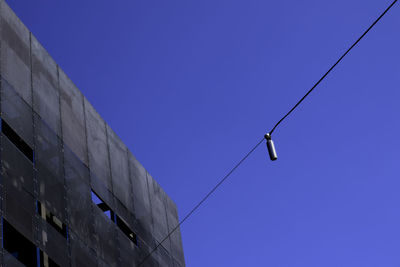 Low angle view of building against clear blue sky