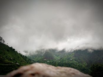 Man on mountain against sky