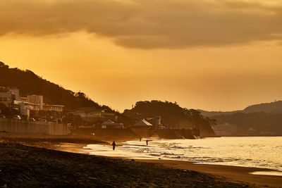 Scenic view of beach against sky during sunset