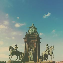 Low angle view of statue against cloudy sky