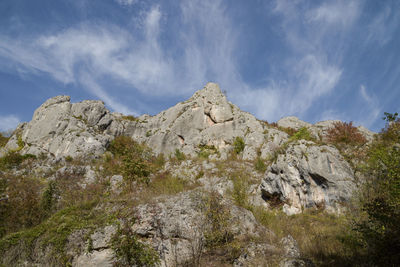 Low angle view of rocky mountains against sky