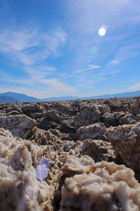Rocks on landscape against blue sky