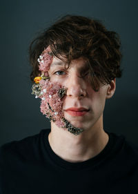 Portrait of young man against gray background