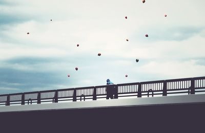 Bridge against cloudy sky